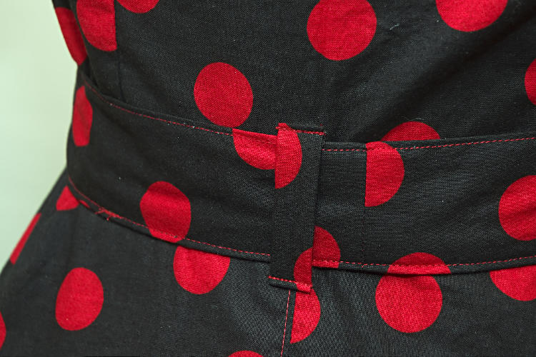 Black dress with red polka dots, back