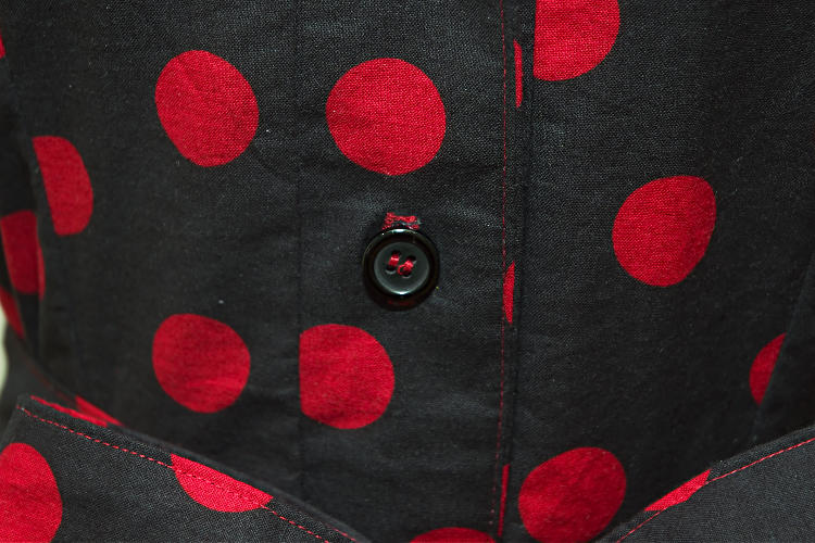 Black dress with red polka dots, closeup